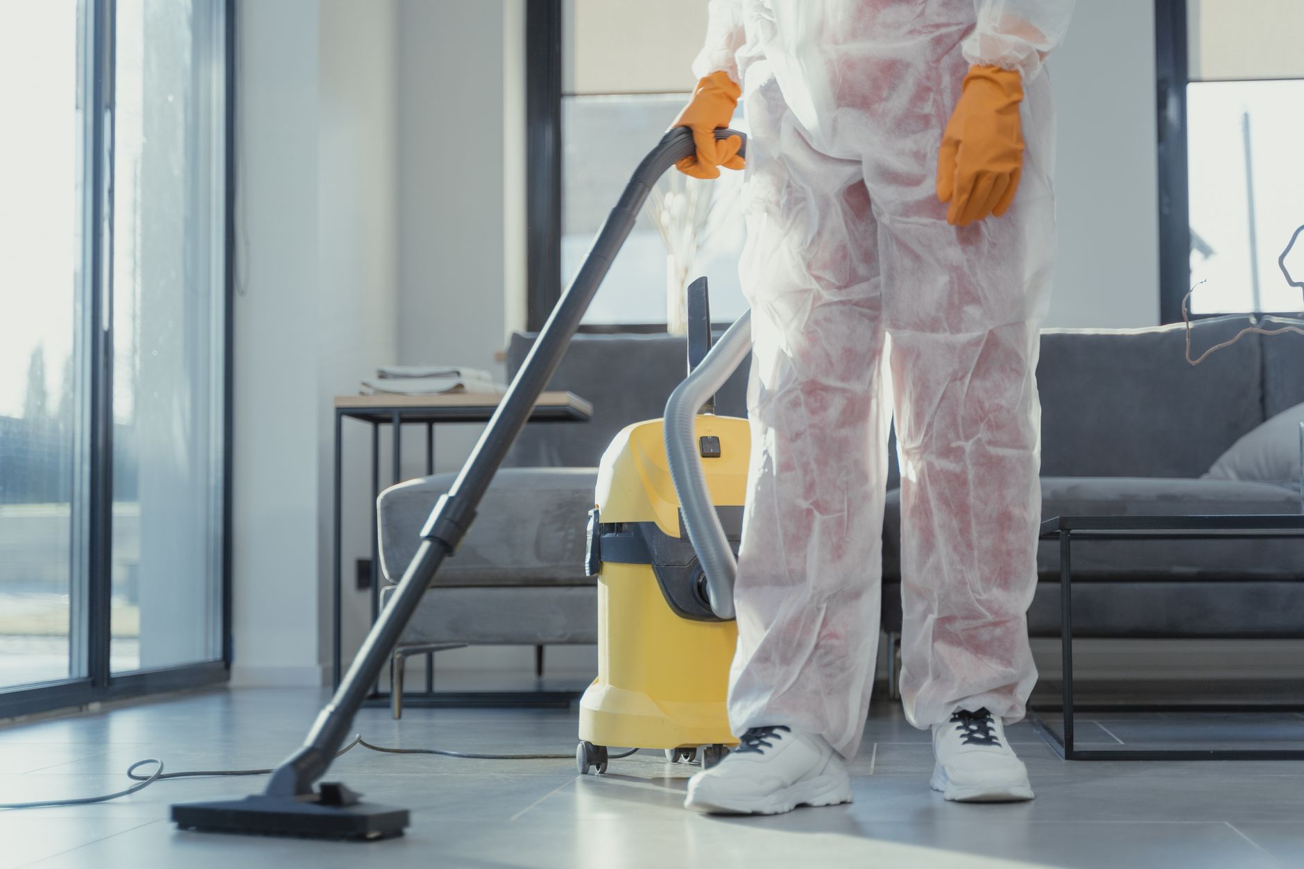 A team of IICRC-certified mold remediation specialists from Prime Pro Mold Removal preparing equipment inside a residential property in Indian Creek, Texas, wearing full PPE.